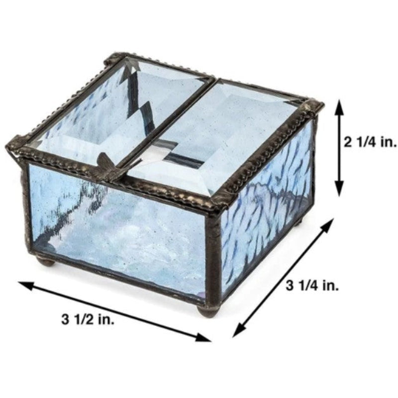 A square glass jewelry box with a hinged lid, featuring light blue patterned glass panels and a dark metal frame. Black arrows and text indicate its dimensions: 3 1/2 inches wide, 3 1/4 inches deep, and 2 1/4 inches high.